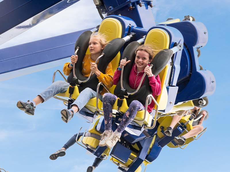 close up of two girls riding the power surge ride at Emerald park