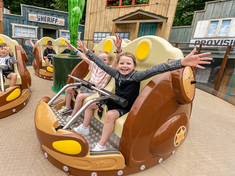 close up of girls waving hands at sheriffs shuffle ride in emerald park