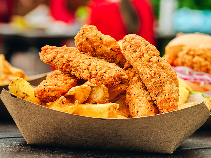 A close up of chicken goujons and fries