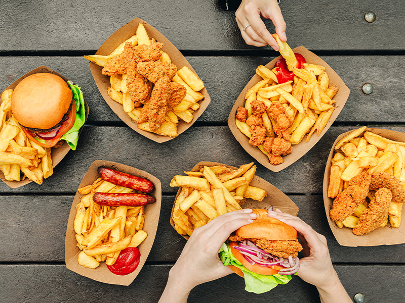 A close up of The Argentinian Grill burgers, chicken goujons, hand-cut fries on bench at Emerald park
