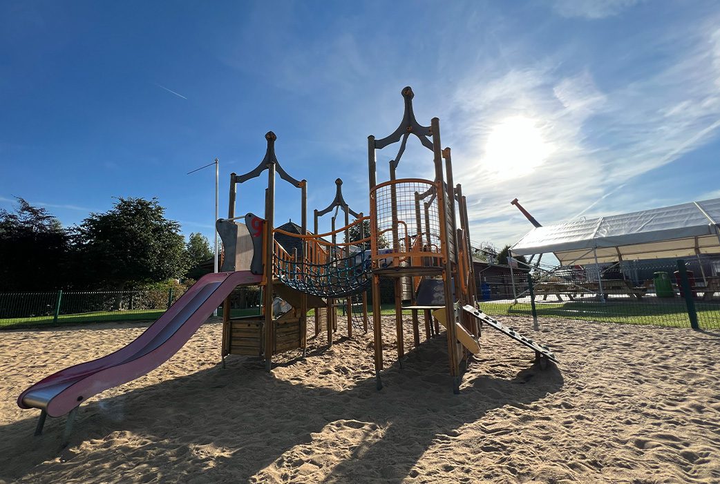 A wide shot of the sand playground area