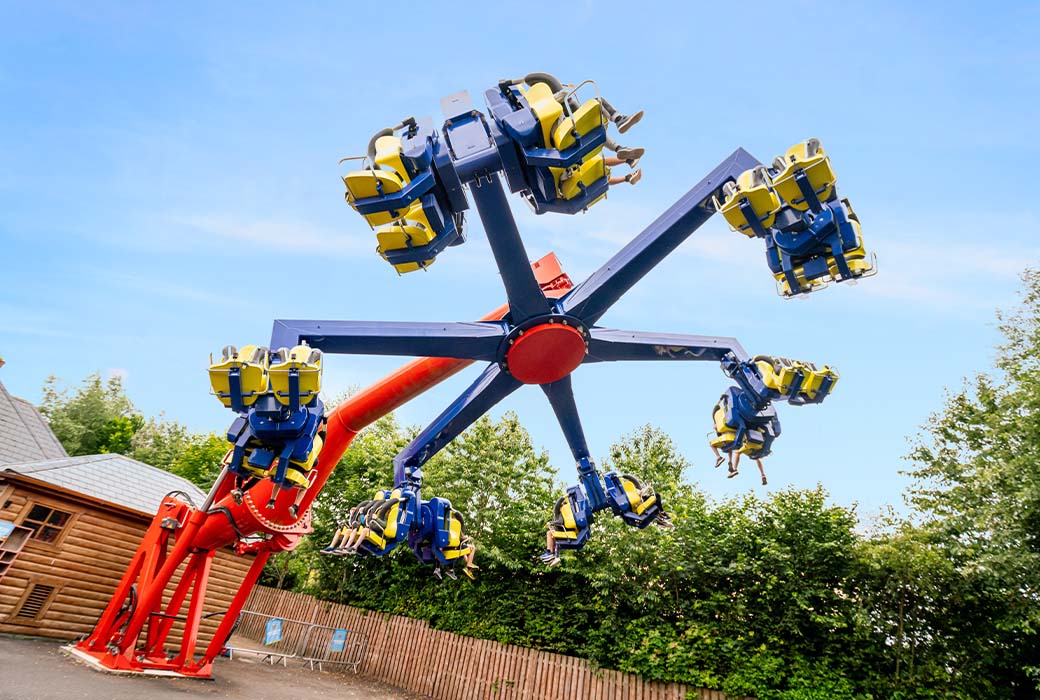 A wide angle of the power surge ride in action at theme park