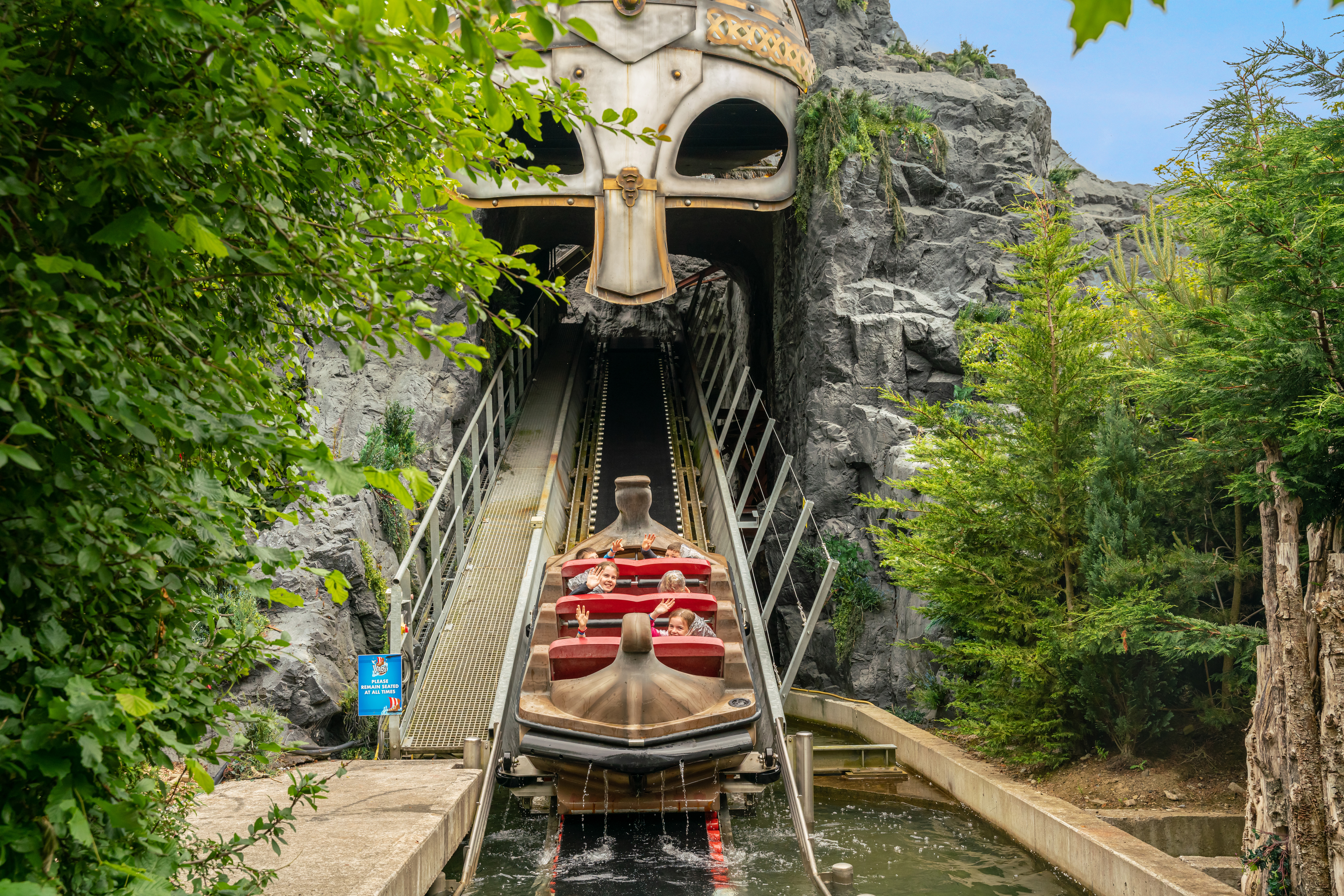 A water flume ride with a boat ascending up a ramp