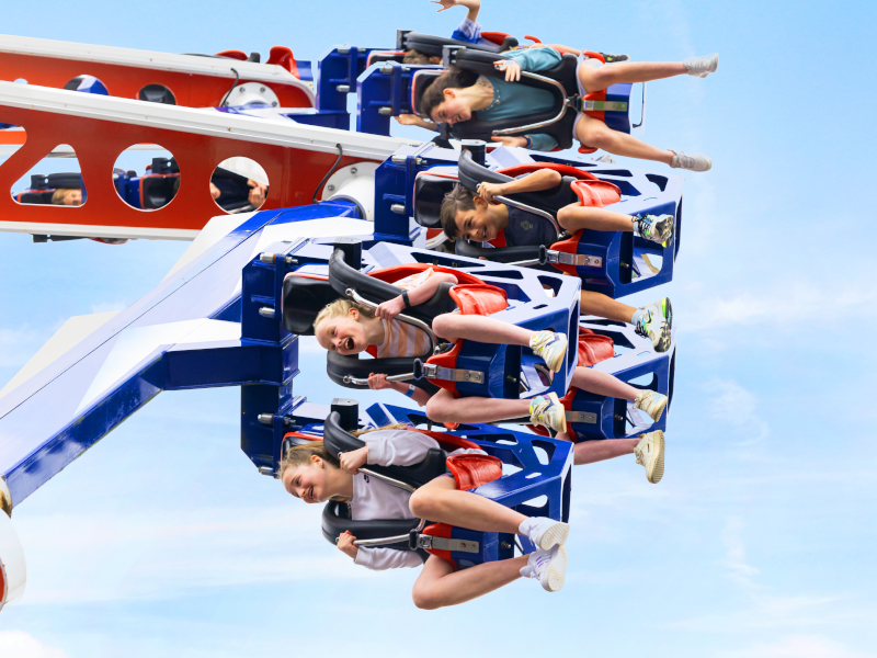 Children are riding the sideways-tilting Endeavour ride.