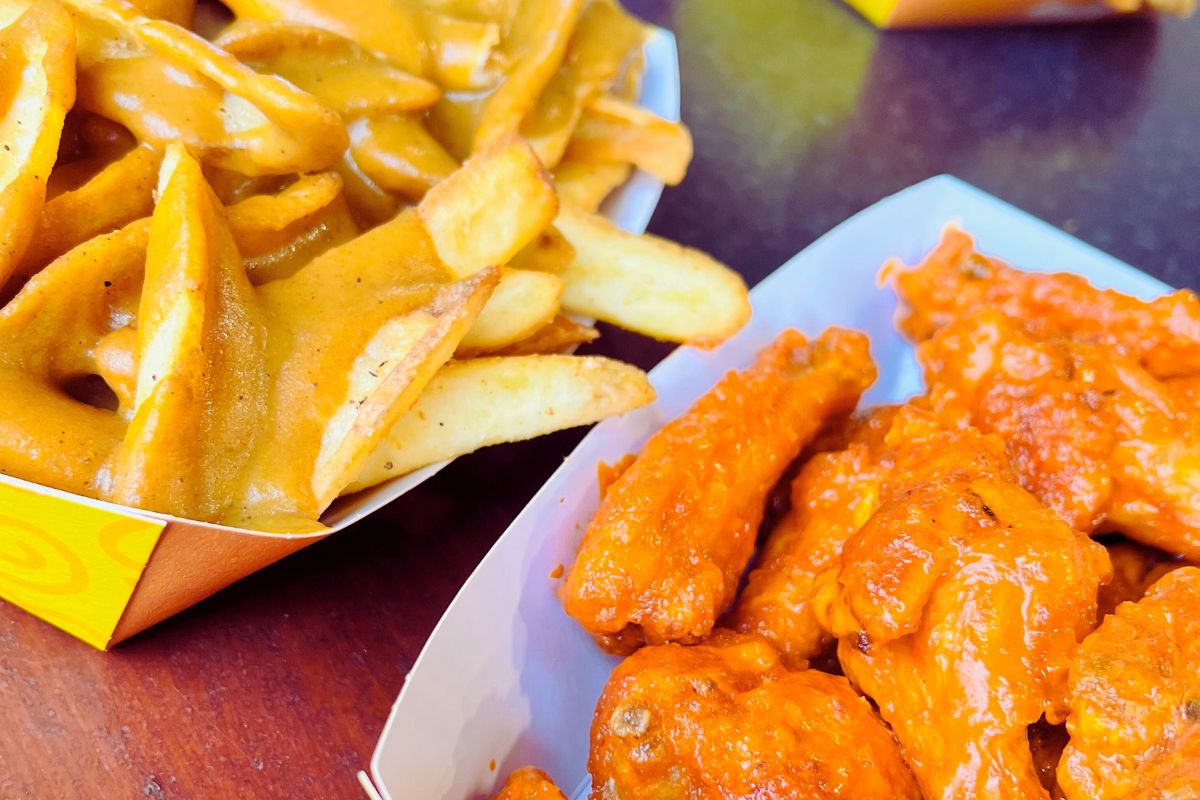 spicy chicken wings and fries topped with curry sauce