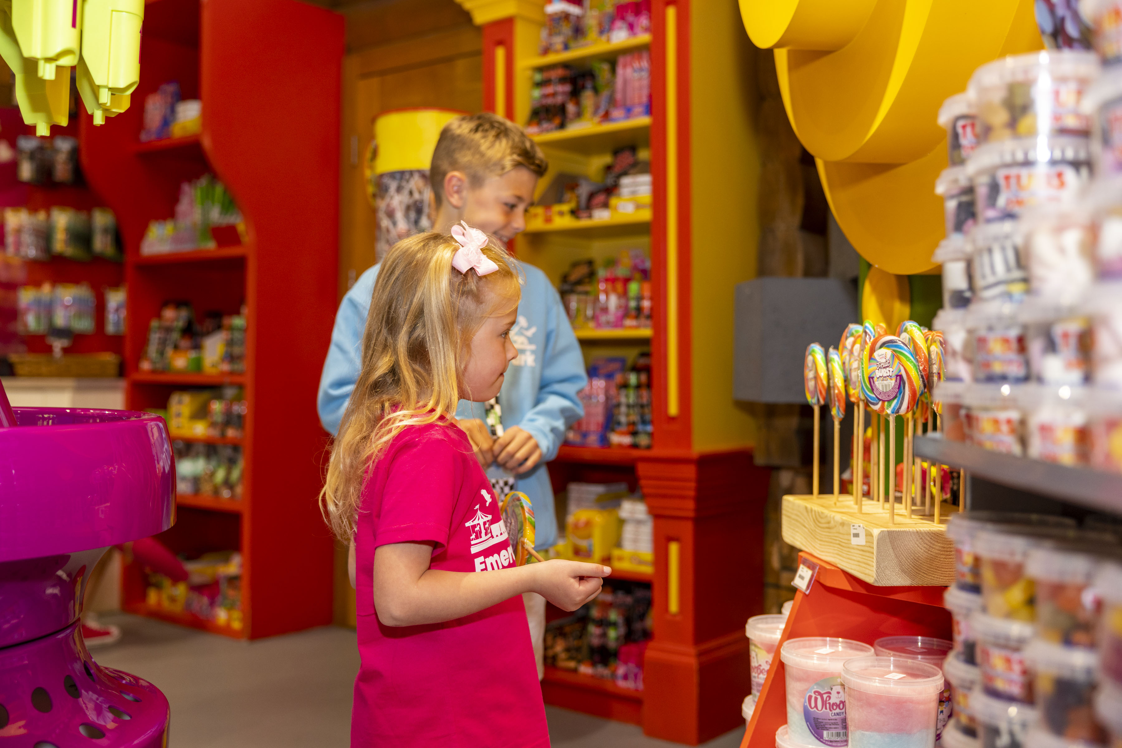 an image of a girl and boy in a sweet shop at Emerald Park looking at treats