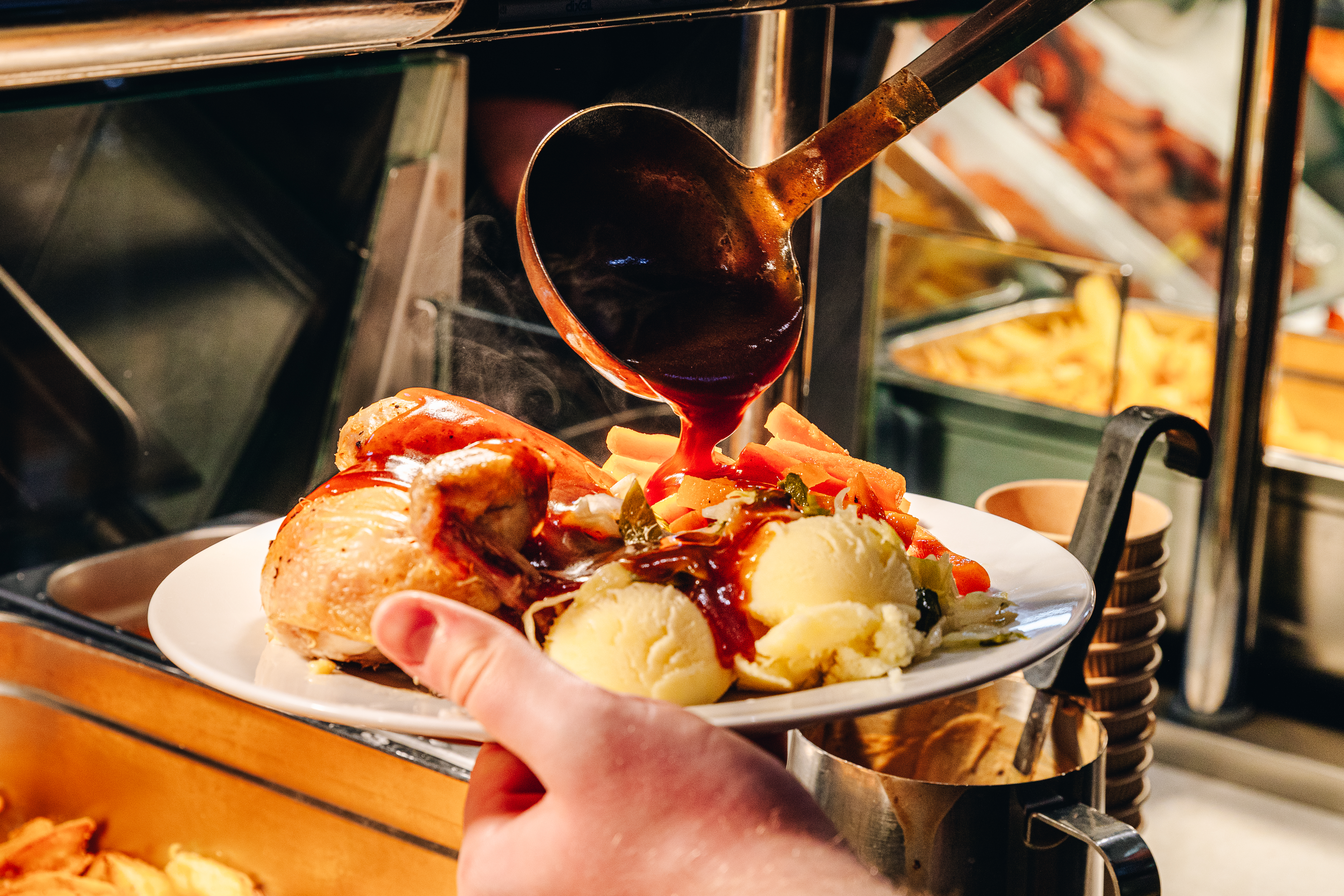 gravy being poured on plate of food at emerald park