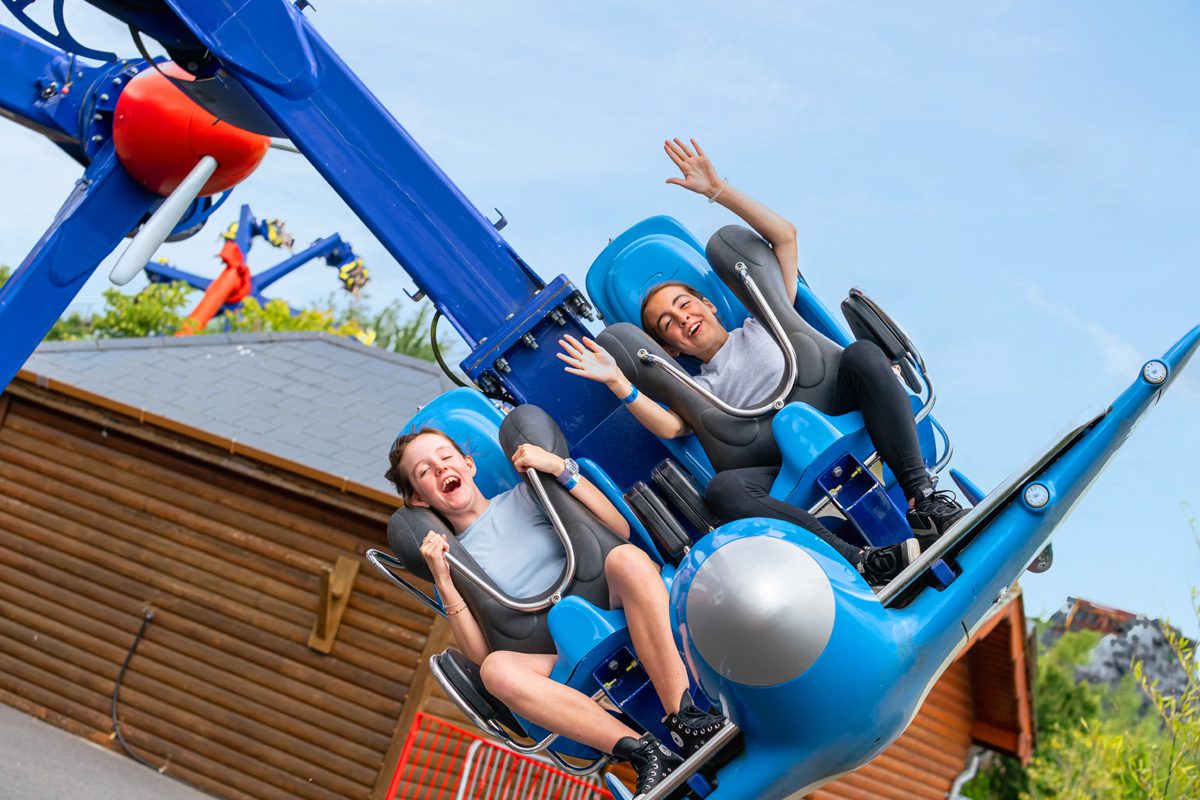 Two kids on the emerald park's air racing ride
