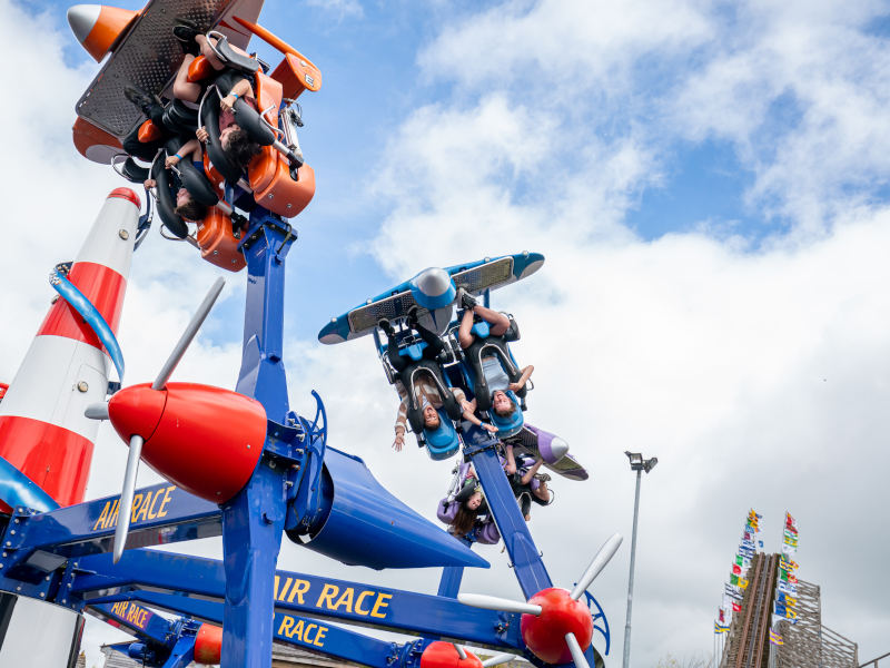 The people on the air racer ride are turned upside down