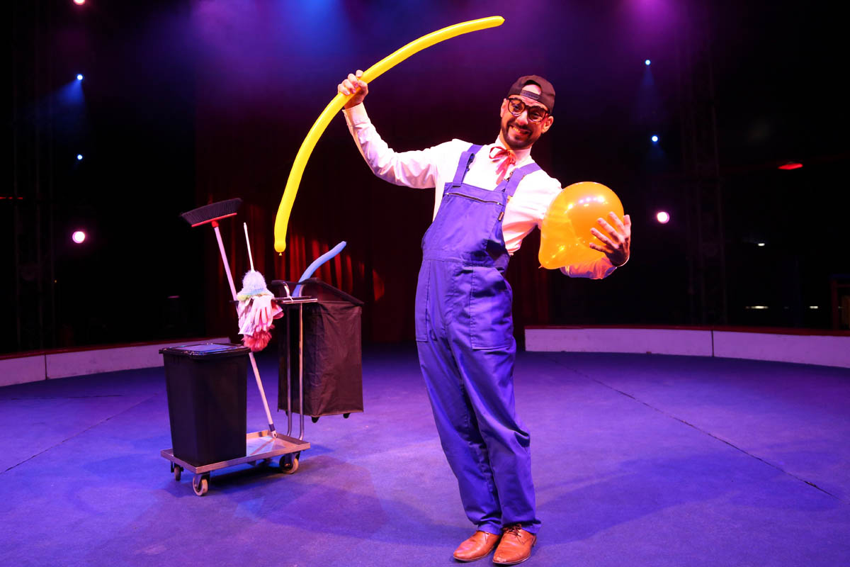 The clown at the Robert Fosset show holding balloons