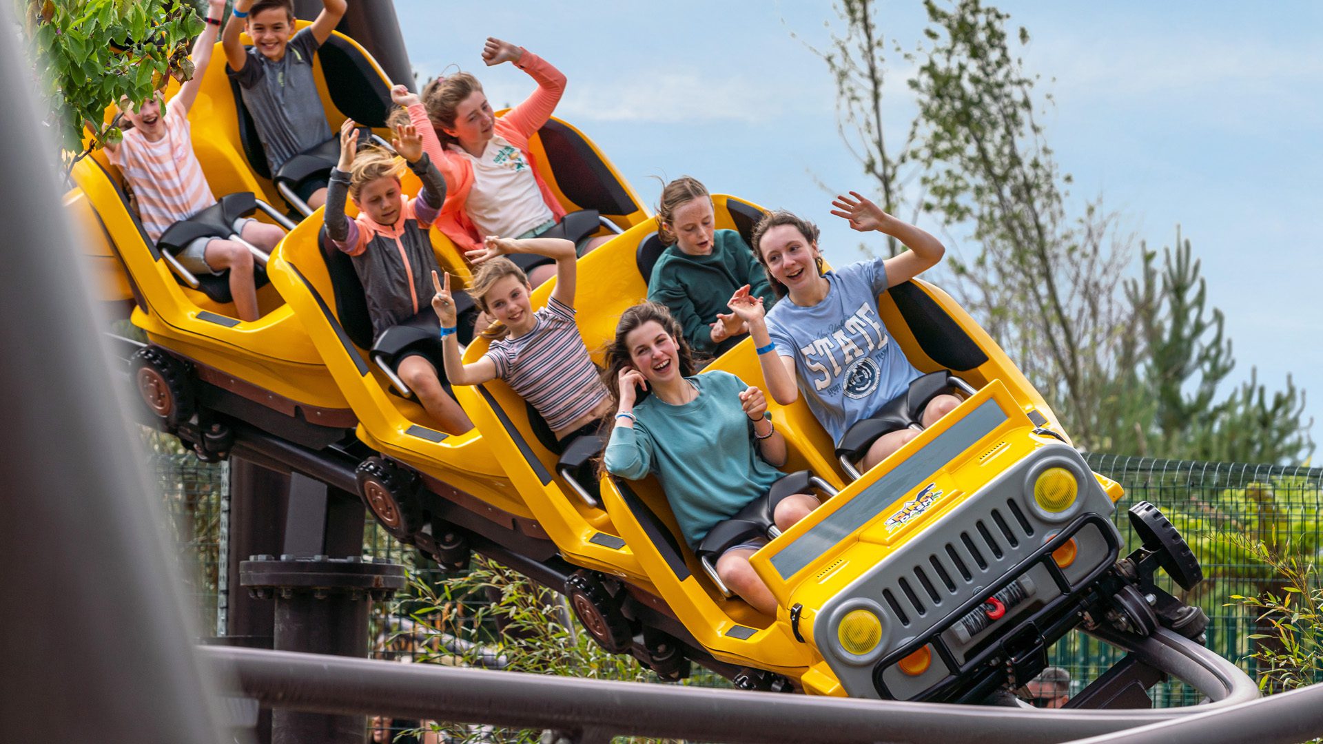 group of children in the middle of dino dash theme park ride emerald park