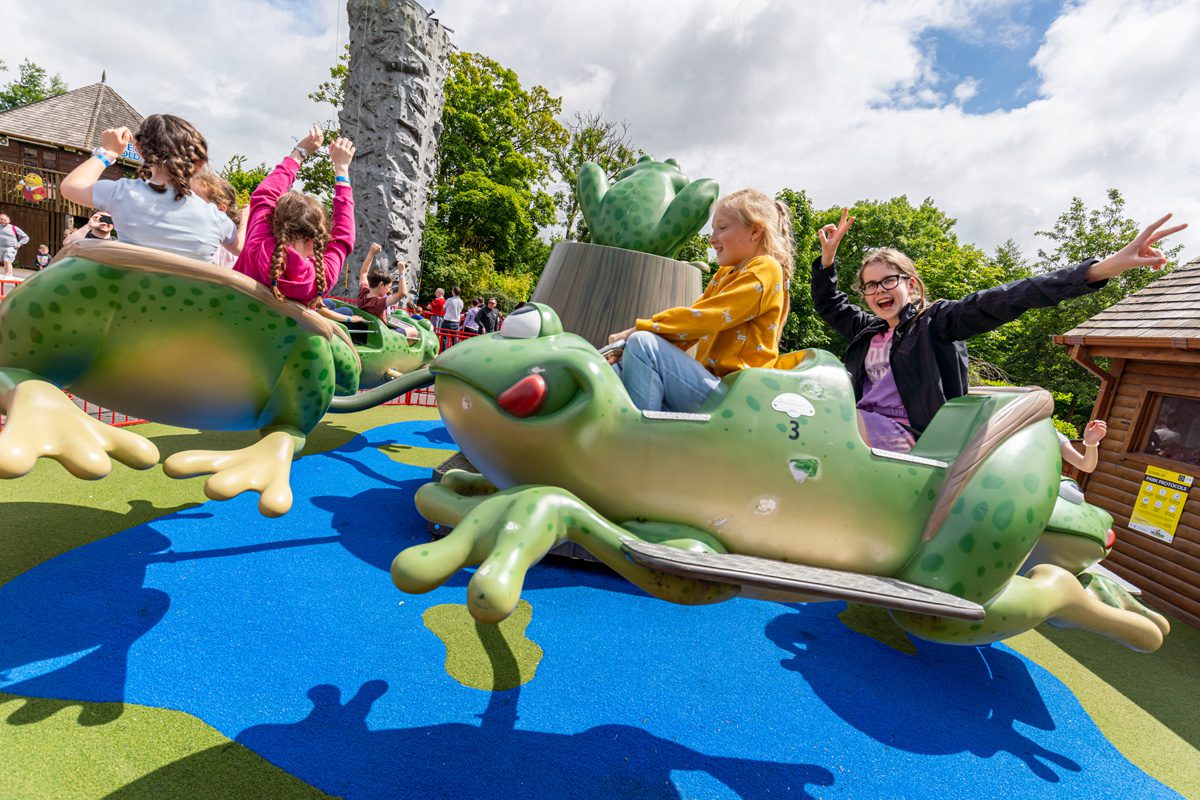Children riding the leapfrog ride at the theme park