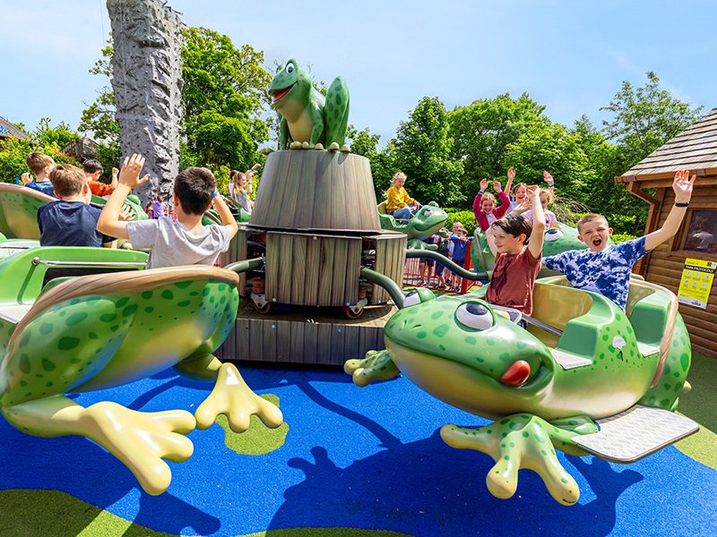 Children having fun riding the leap frog ride