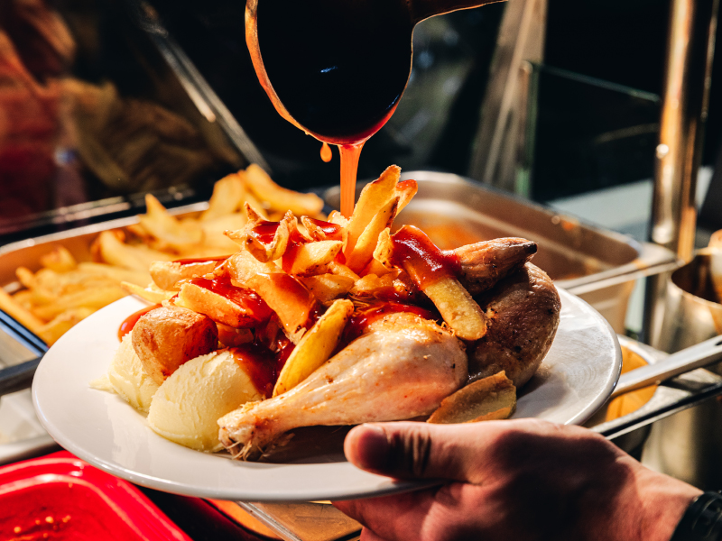 Gravy being poured on chips and chicken at Lodge restaurant