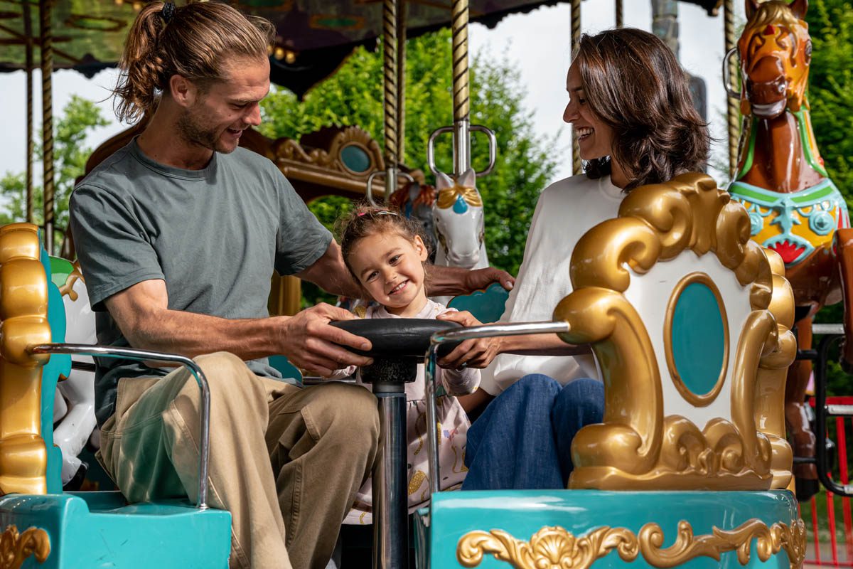 family of three on a ride at emerald park