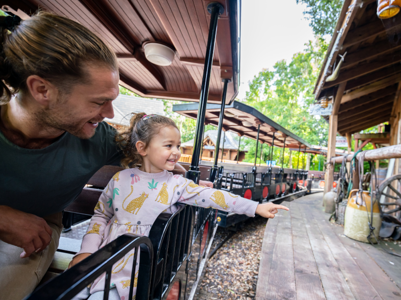 A father and child riding the steam train at Emerald park