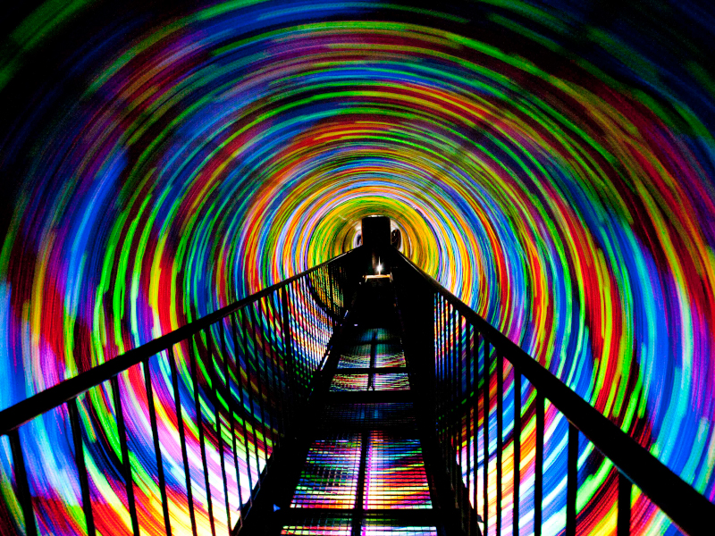 within the vortex tunnel, which is illuminated by bright lights.