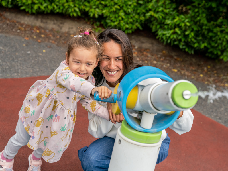 mother and daughter pointing a water gun