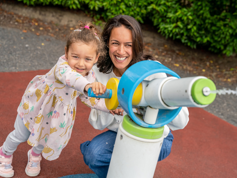 A mother and daughter having with water gun at the water fun area