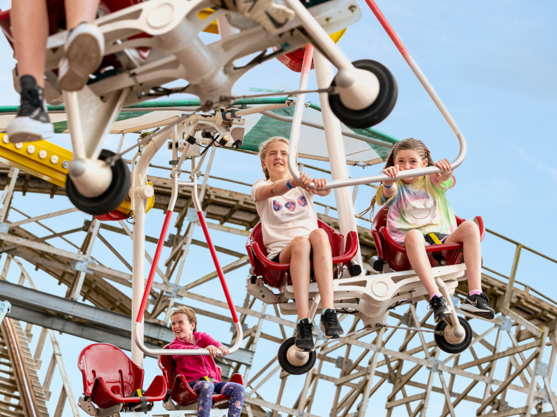Two children holding on tight while riding the Windstar ride