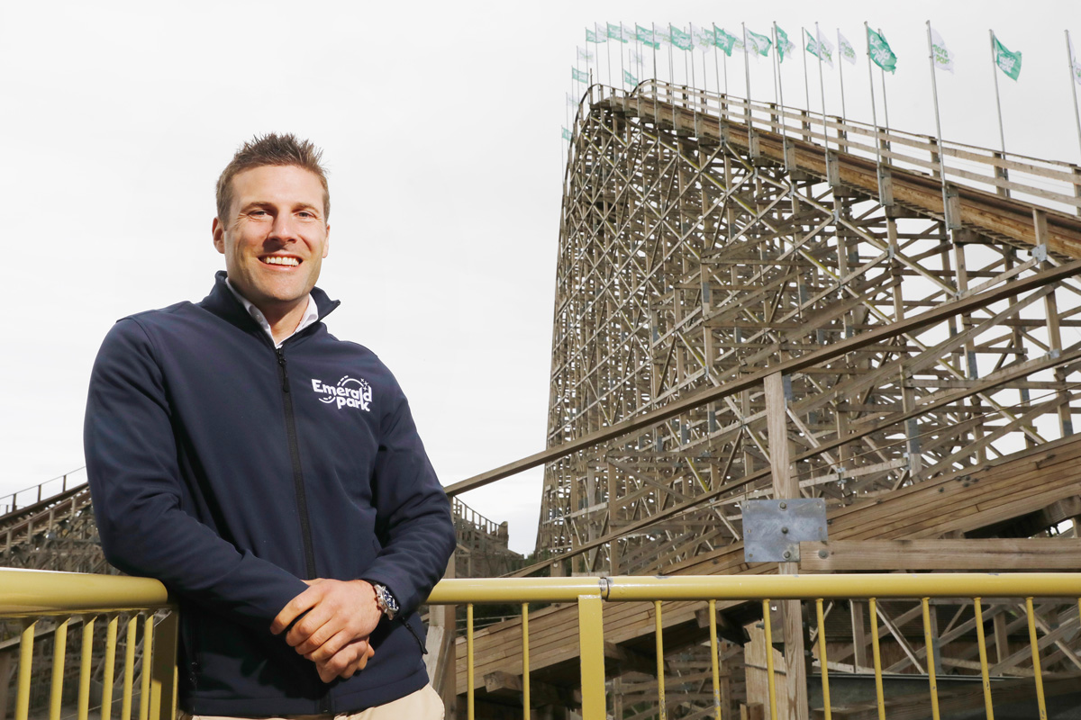 Emerald park worker standing in front of the Cu Chulainn rollercoaster at Emerald Park