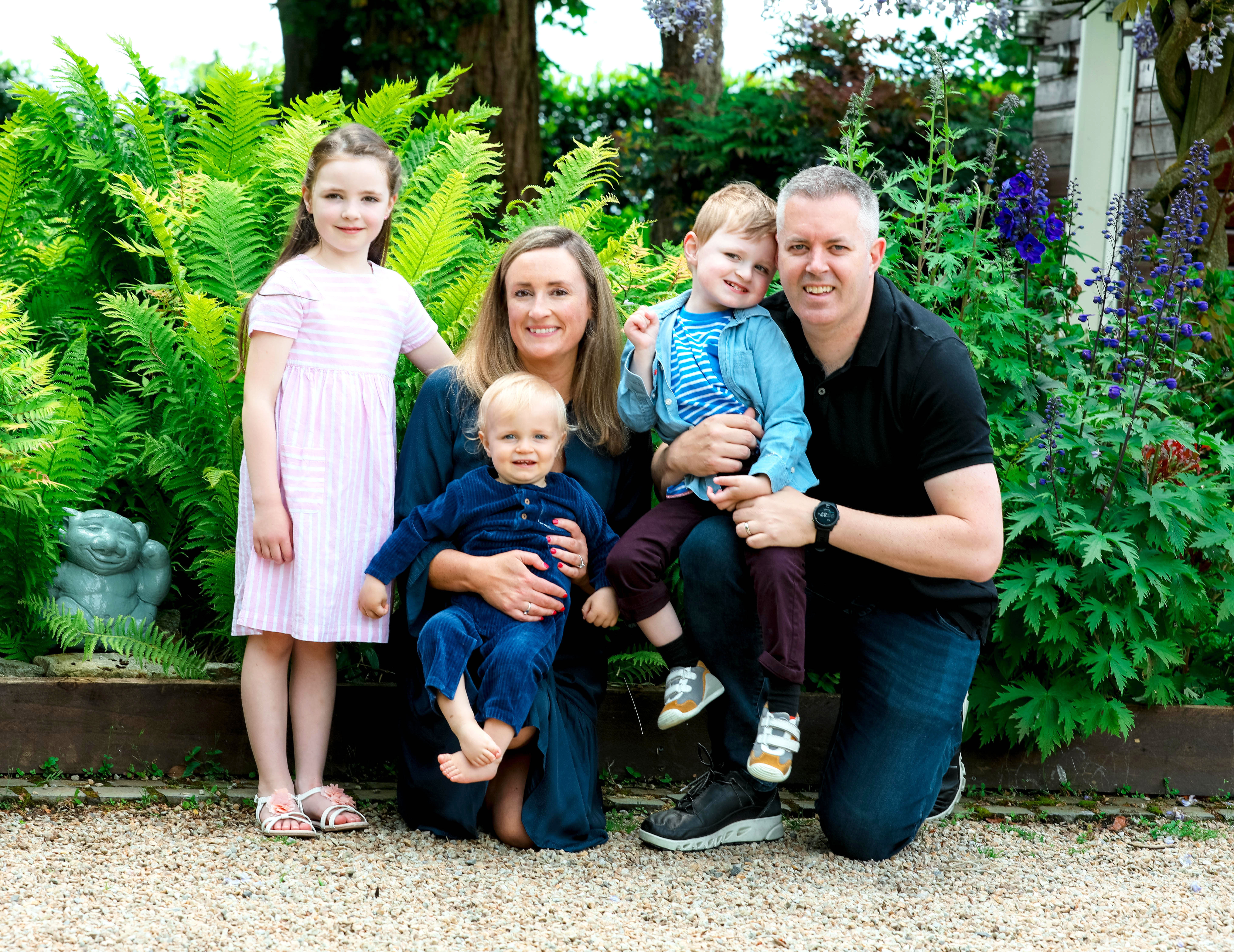 a family photo with a Jack & Jill family. Including three children a mother and father smiling