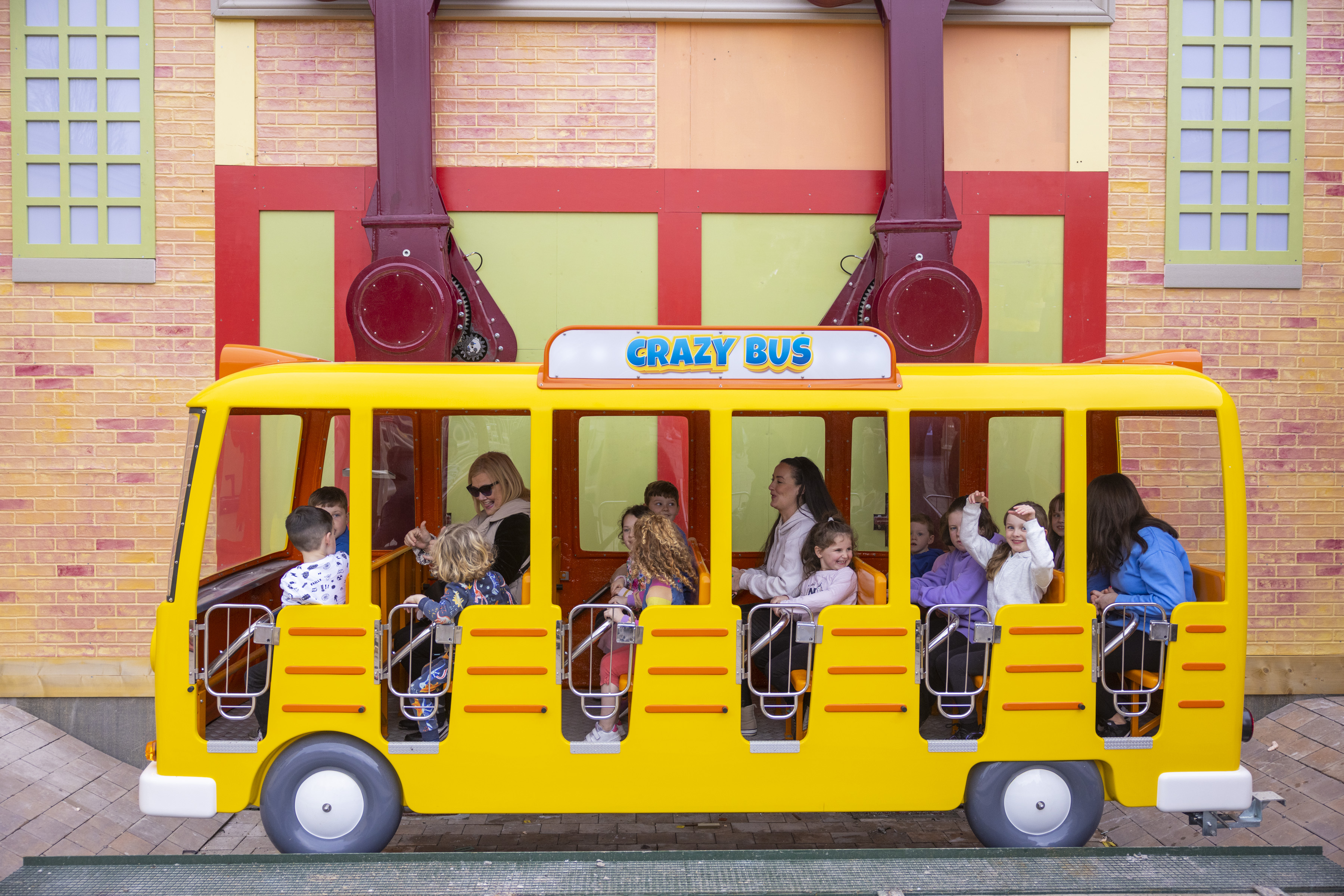 a yellow school bus themed attraction with a group of children