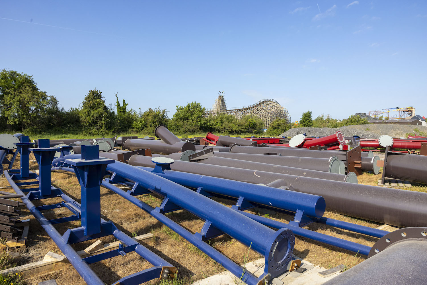 blue, red, and brown rollercoaster track in a field