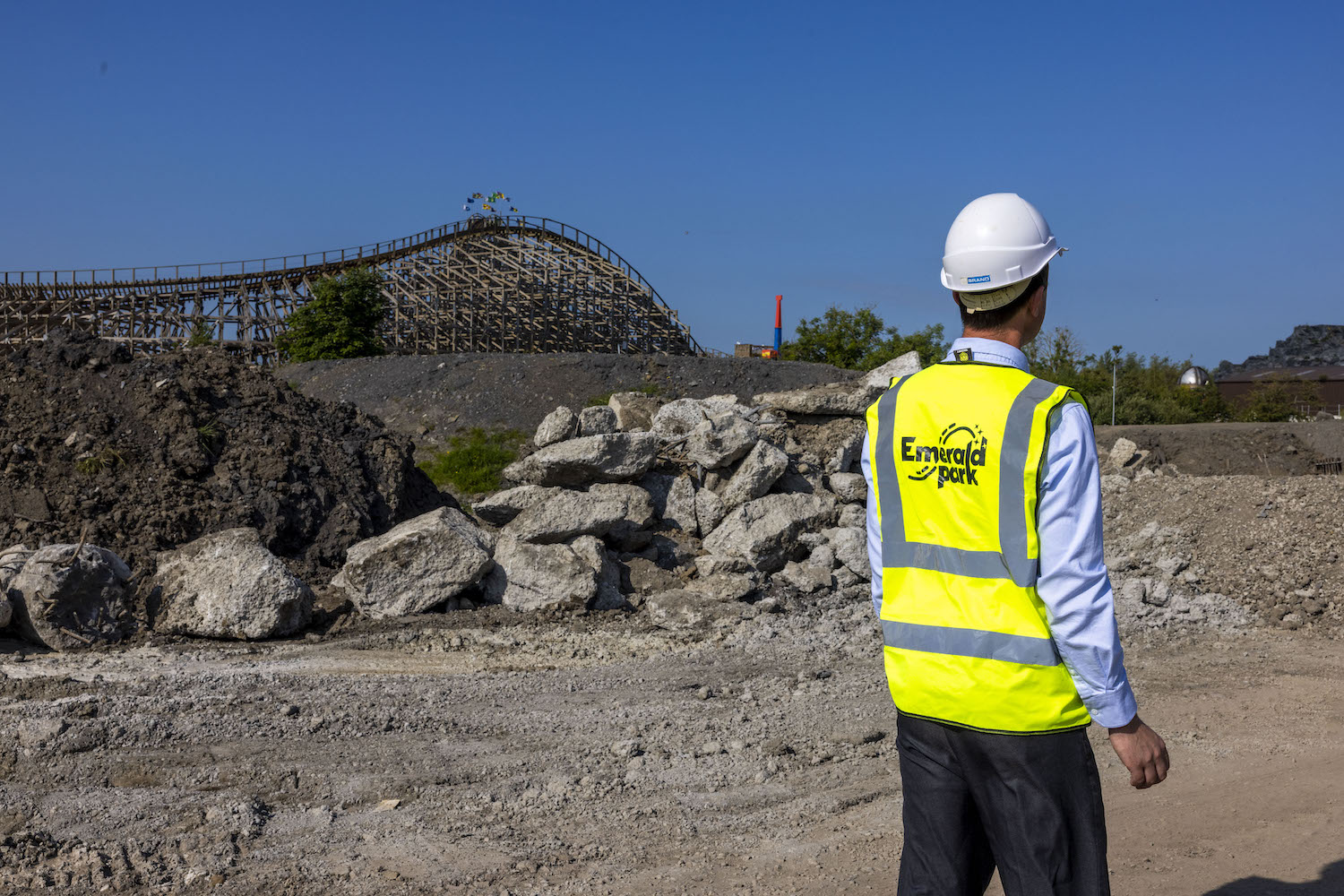 a construction site at Emerald Park with a man standing with a hard hat