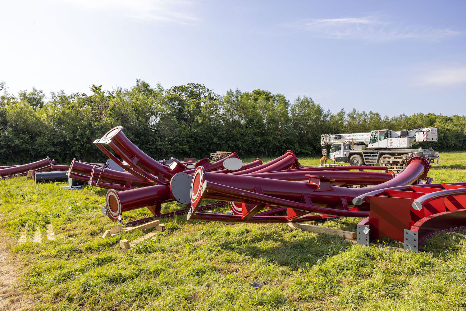 red rollercoaster track in a field