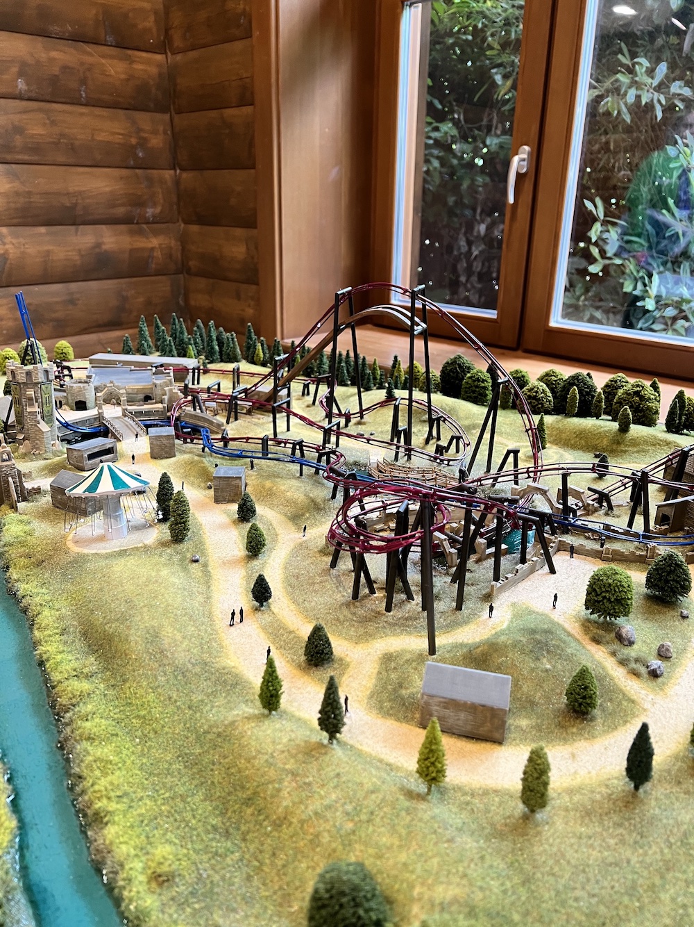 a model of a themed land at a theme park with two rollercoasters