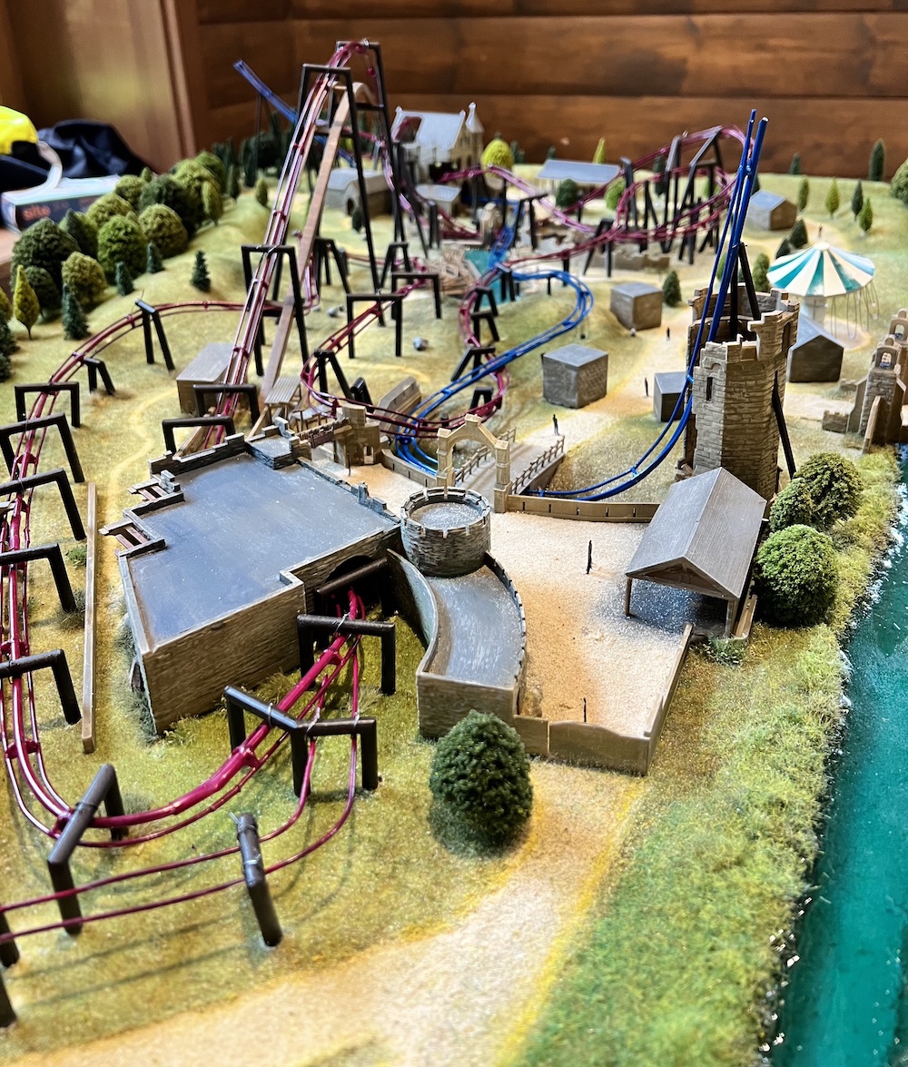 a model of a themed land at a theme park with two rollercoasters