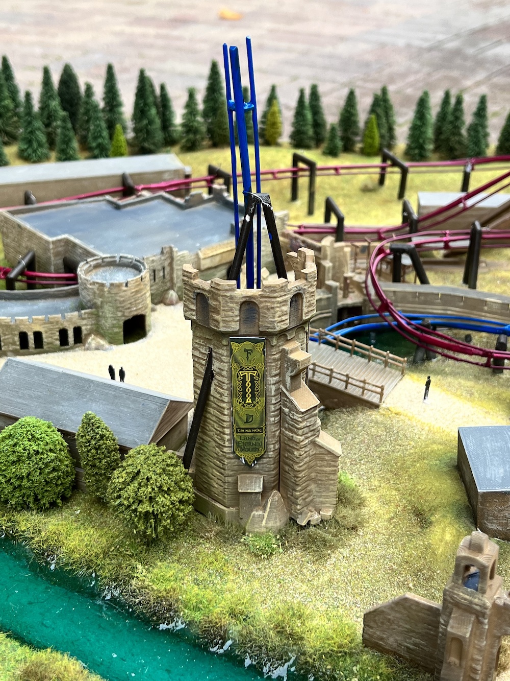 a 3D model of a ruined tower with a rollercoaster going through the top
