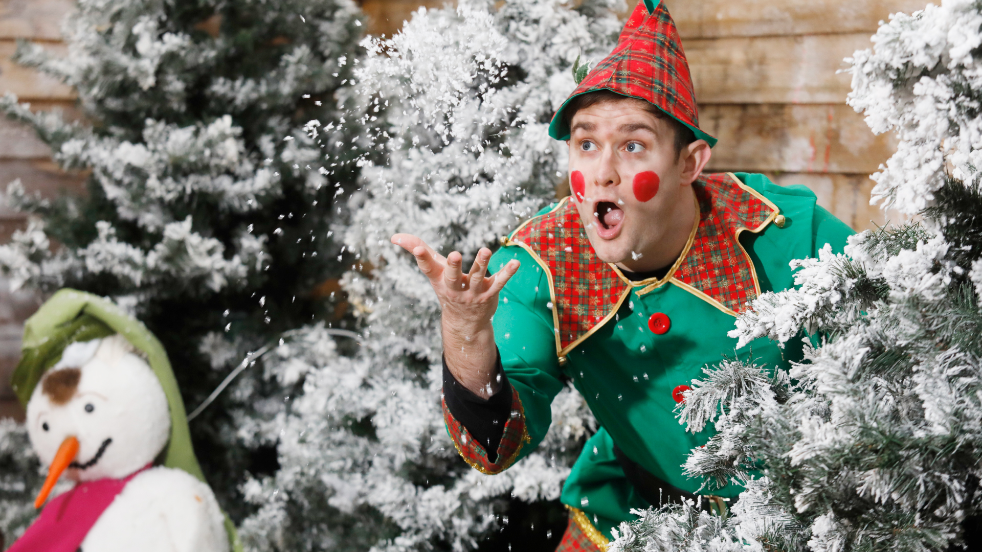 an elf throwing snow in snowy trees