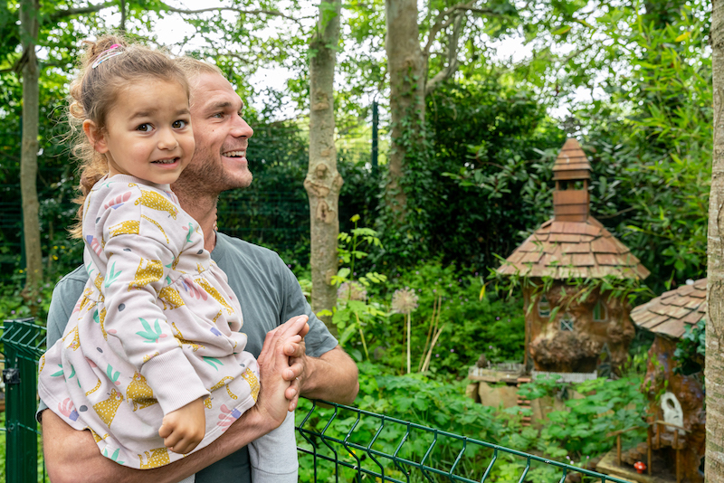 a man holding a child smiling