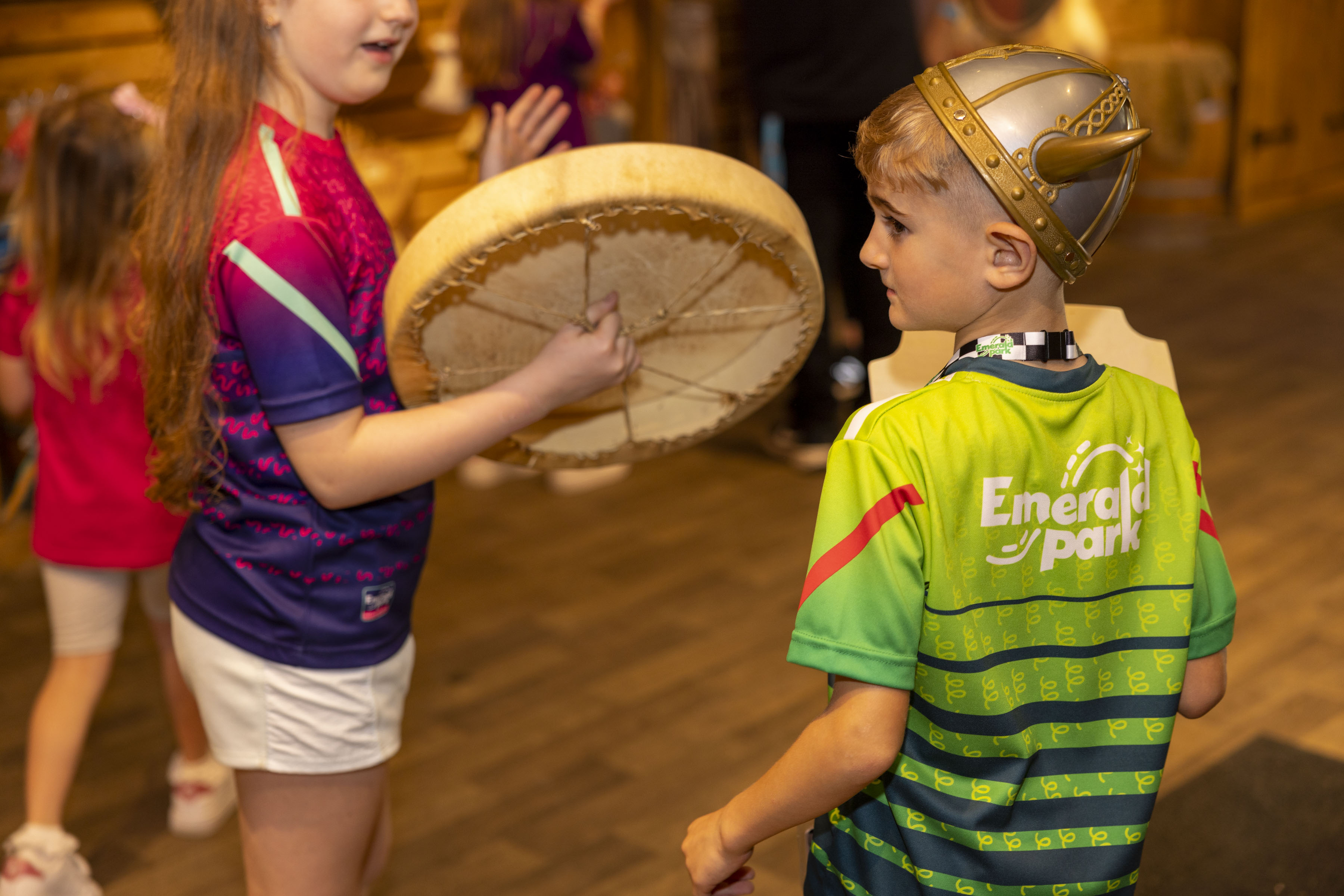 a boy and girl dressed in Emerald Park clothing and a Viking hat