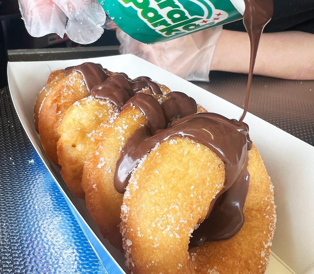 a portion of doughnuts at Emerald Park with chocolate drizzled on top from a tub