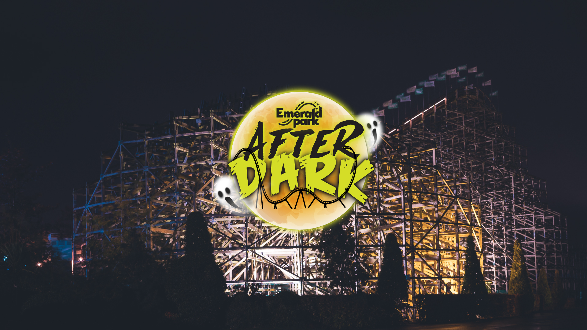 a shot of Cu Chulainn at Emerald Park in the dark. Underneath the attraction is lit up. An Emerald Park logo for a Halloween event called After Dark overlays the image